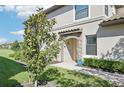 Inviting front entrance showcasing lush landscaping and charming stone accents at 18117 Gawthrop Dr # 101, Lakewood Ranch, FL 34211