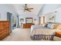 Spacious bedroom with king bed, dresser, ceiling fan, and sliding door access to lanai at 1878 Killdeer Ct, Venice, FL 34293