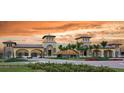 Grand entrance to the community featuring lush landscaping, elegant architecture, and a welcoming atmosphere at 20186 Benissimo Dr, Venice, FL 34293