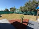 Private backyard space with well-maintained lawn, landscaping, and privacy fence at 22332 Midway Blvd, Port Charlotte, FL 33952