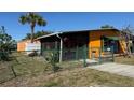 A well-maintained single-story home with screened-in porch and green fencing offers privacy at 22332 Midway Blvd, Port Charlotte, FL 33952
