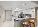 Modern kitchen with granite countertops, stainless steel appliances, and convenient breakfast bar seating at 2320 Terra Ceia Bay Blvd # 206, Palmetto, FL 34221