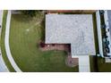 Aerial view of a home with a new roof, green lawn, and paved walkways highlighting the property's landscaping at 2412 15Th W St, Palmetto, FL 34221