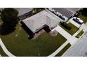 Aerial view showcasing a neatly landscaped home with a spacious yard, driveway, and a well-maintained roof at 2412 15Th W St, Palmetto, FL 34221