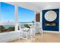 Bright dining area with water views, featuring a bar-height table and modern decor at 340 Gulf Of Mexico Dr # 115, Longboat Key, FL 34228