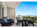 Spacious patio with comfortable seating, offering stunning water views at 340 Gulf Of Mexico Dr # 115, Longboat Key, FL 34228