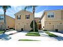 Charming townhome with a well-manicured lawn, attached garages, and lush landscaping at 3478 Parkridge Cir # 32-104, Sarasota, FL 34243