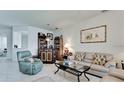 Open concept living room featuring tile flooring, a bar, and lots of natural light at 3478 Parkridge Cir # 32-104, Sarasota, FL 34243