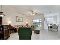 Bright living room with tile flooring and a view of the screened patio overlooking the pond at 3478 Parkridge Cir # 32-104, Sarasota, FL 34243