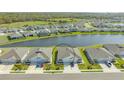 Picturesque aerial shot of paired homes with lake views and meticulously kept lawns at 427 157Th E Ct, Bradenton, FL 34212