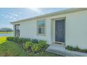 Close up of the front entrance and side of the house, with a view of the water at 427 157Th E Ct, Bradenton, FL 34212