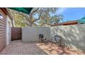 This brick patio features seating and access to a wooden gate, perfect for relaxing outdoors at 4423 Park Lake N Ter, Bradenton, FL 34209