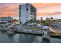 Modern condo with a private pool and canal access, with vibrant sky at sunset at 4822 Ocean Blvd # 11E, Sarasota, FL 34242