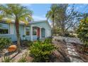 Inviting exterior featuring lush tropical plants and stylish walkway leading to the front entrance at 511 68Th St, Holmes Beach, FL 34217