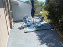 Relaxing outdoor patio featuring a table, chairs, umbrella, and decorative rug for comfortable lounging at 5235 Cherry Hill Ave, Sarasota, FL 34234