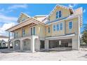 New construction home showing the open garages underneath the main floor at 525 68Th St St, Holmes Beach, FL 34217