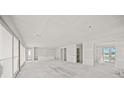 Spacious living room with large windows offering plenty of natural light at 525 68Th St St, Holmes Beach, FL 34217
