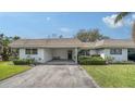 Charming single-story home featuring a covered carport and landscaped yard at 534 Sutton Pl, Longboat Key, FL 34228