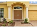 Close-up of the inviting double door entry framed by classic pillars at 5342 98Th E Ave, Parrish, FL 34219