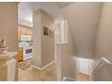 Inviting entryway features neutral tones, tile flooring, and staircase access to the upper level at 5700 Bentgrass Dr # 209, Sarasota, FL 34235