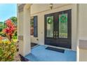 Inviting front entry with decorative wreaths on double glass doors at 6156 41St E St, Bradenton, FL 34203