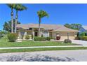 Charming single-story home with well-manicured lawn, mature palm trees, and welcoming curb appeal at 6511 Turners Gap Rd, Bradenton, FL 34203