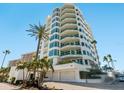 Stunning high-rise exterior features lush landscaping and convenient garage access at 655 Longboat Club Rd # 16B, Longboat Key, FL 34228