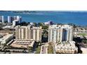 View of upscale waterfront condo buildings with beautiful views of bay and modern architectural design and lush landscaping at 750 N Tamiami Trl # 604, Sarasota, FL 34236