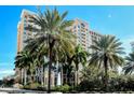 Upscale condo complex with lush palms, fountain and beautiful architectural details near entrance and signage at 750 N Tamiami Trl # 604, Sarasota, FL 34236