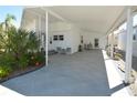 Spacious carport with ample parking, outdoor seating, and direct access to the home's entrance at 789 N Green Cir, Venice, FL 34285