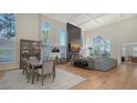 A bright, spacious living room featuring hardwood floors, tall ceilings, and plenty of natural light at 8025 Via Fiore, Sarasota, FL 34238