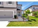 Charming two-story home features a spacious driveway and a beautifully landscaped front yard at 8262 Velda Trl, Sarasota, FL 34241