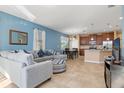 Bright living room showcases an open layout with comfortable seating, tile floors, and easy access to kitchen at 8323 Enclave Way # 104, Sarasota, FL 34243