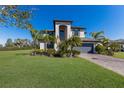 Charming two-story home featuring a well-manicured lawn and a paver driveway at 10905 Copperlefe Dr, Bradenton, FL 34212