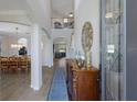 Elegant foyer with high ceilings, tiled floors, and decorative rug leading into the dining and living areas at 10905 Copperlefe Dr, Bradenton, FL 34212