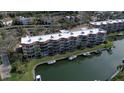 Waterfront condo building with boat slips, showcasing the building's architecture and community layout at 1257 S Portofino Dr # 208, Sarasota, FL 34242