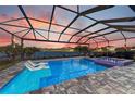Screened-in pool and spa overlooking a tranquil lake, perfect for relaxation and outdoor enjoyment at 13228 Saw Palm Creek Trl, Lakewood Ranch, FL 34211