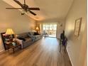 Inviting living room featuring new vinyl flooring, a cozy sofa and neutral paint at 1412 56Th W St # 1412, Bradenton, FL 34209
