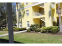 A well-landscaped building exterior showcasing the well-maintained grounds and exterior stairwell at 2060 Willow Hammock Cir # 201, Punta Gorda, FL 33983