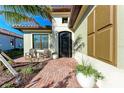 Charming front porch with chairs, planters, and a brick walkway leading to the entrance at 2322 5Th E St, Palmetto, FL 34221