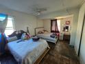 Shared bedroom with tile flooring, 2 beds, a vanity, and natural light from two windows at 303 60Th W Ave, Bradenton, FL 34207