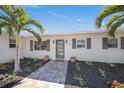 Front entrance with lovely landscaping and a charming walkway that leads to the front door at 317 Gulf Dr, Venice, FL 34285