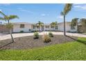 Inviting home with palm trees and freshly landscaped yard, enhancing curb appeal at 317 Gulf Dr, Venice, FL 34285