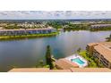 Scenic aerial view of community lake, pool, and condo buildings at 3525 Lake Bayshore Dr # 103J, Bradenton, FL 34205