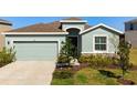 Charming single Gathering home with a two-car garage, neutral paint, and simple, well-manicured landscaping at 3677 Turning Tides Ter, Bradenton, FL 34208