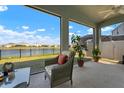 Relaxing screened lanai with comfortable seating and a beautiful water view at 3677 Turning Tides Ter, Bradenton, FL 34208