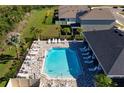 Community pool with sun loungers and ample space for recreation and relaxation at 3677 Turning Tides Ter, Bradenton, FL 34208