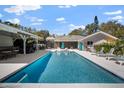 Large pool, patio, and outdoor kitchen, perfect for entertaining, with ample seating at 4711 Placid Cir, Sarasota, FL 34231