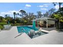Stunning pool with sun loungers and covered outdoor kitchen, ideal for entertaining guests at 4711 Placid Cir, Sarasota, FL 34231