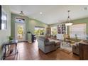 Bright and airy living room featuring tile floors, a large window with backyard views, and a cozy seating area at 5227 Lansdowne Way, Palmetto, FL 34221